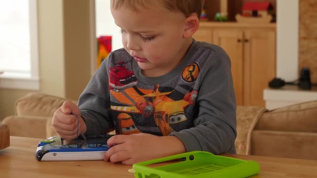 A little boy playing games on a childrens tablet