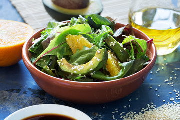 Fresh salad with avocado and orange