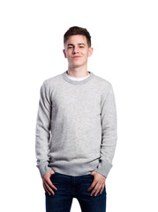 Obraz premium Teenage boy in jeans and sweater. Studio shot, isolated.