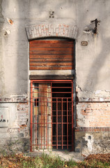 Fototapeta na wymiar door of an old abandoned house secured with the iron bars in Frydek-Mistek, Czech Republic