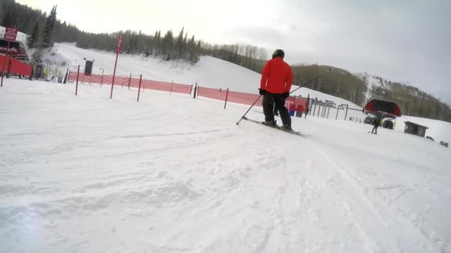 Slow motion man skiing into lift line