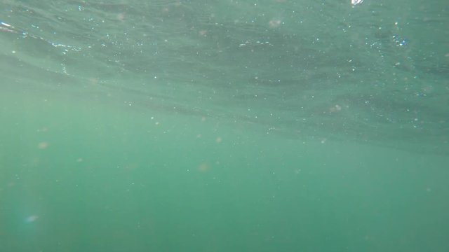 An underwater shot of rough ocean waves on the surface of sea