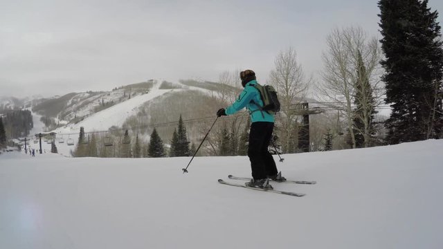 A woman skiing at a mountain resort on a cold winter day