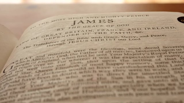 Closeup on reading Holy Bible dolly shot