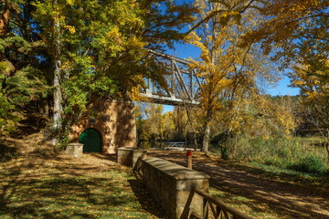 Iron bridge over the river, in a sunny autumn morning.