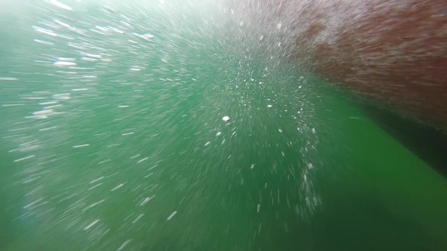 Underwater shot of bubbles passing by while in the boat