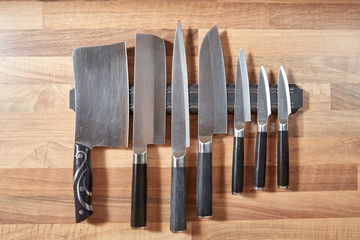 Seven kitchen knives mounted on the wall