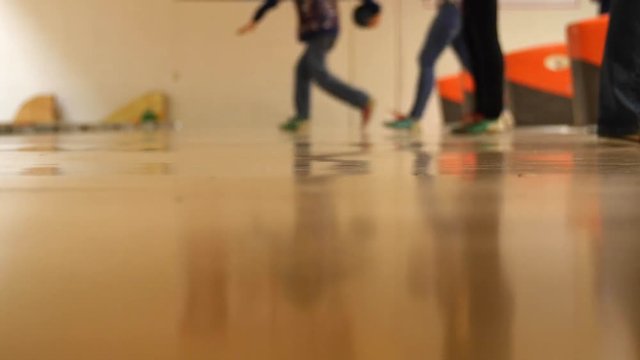 Low shot people bowling in a small town bowling alley