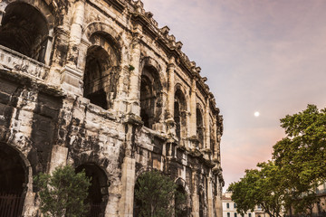 Arena of Nimes at sunrise and moonset