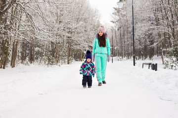Mother and child enjoying beautiful winter day outdoors
