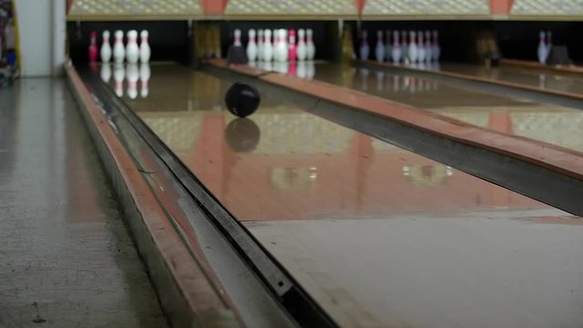 A slow motion shot of a bowling ball hitting the pins