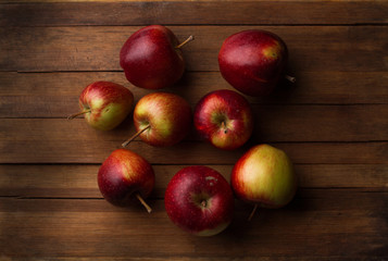 Organic small garden ripe apples on wooden plank