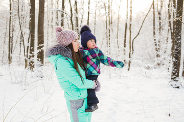 Fototapeta na wymiar Mother and child enjoying beautiful winter day outdoors
