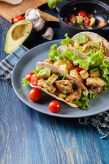 Authentic mexican tacos with chicken and salsa with avocado, tomatoes and chillies