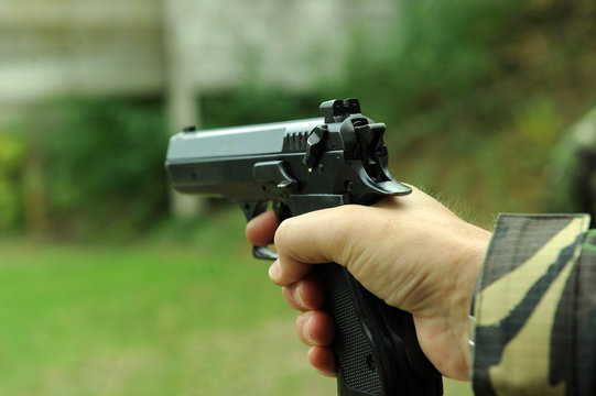 Man holding a pistol in his hands, ready to shoot