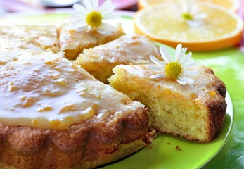  orange cake and chamomile on a green plate