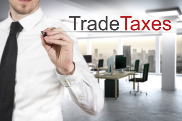 businessman writing trade taxes in the air