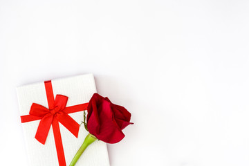 White gift box and red roses on white background
