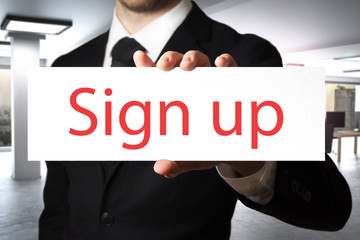 businessman holding sign sign up