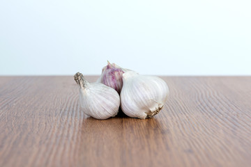 Garlic on a wooden table. Protection from the flu in the winter.