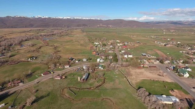 Aerial shot of a rural town and fields in springtime