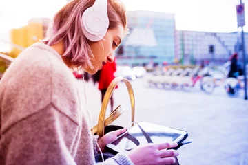 Foto op Canvas Young beautiful caucasian purple grey hair woman outdoor in the city using tablet and listening music with head phones - music, technology, social network concept © Eugenio Marongiu