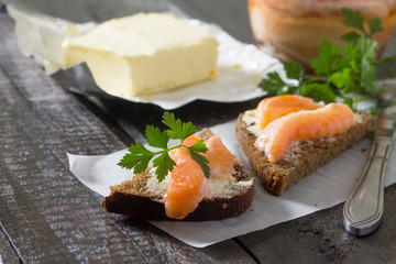 Salt fillet of salmon with butter on rye bread, breakfast concep