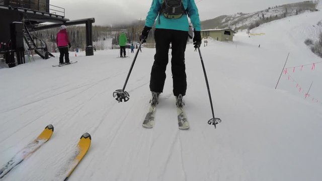 Woman skiing at mountain resort on a cold winter day