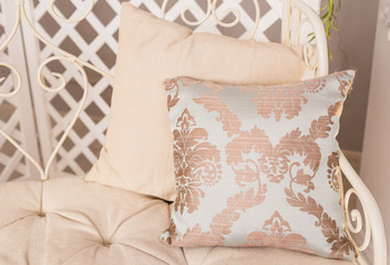 Stylish white armchair or sofa with pillows.