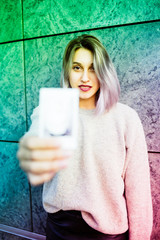 Young beautiful caucasian purple grey hair woman outdoor in the city showing blank postcard