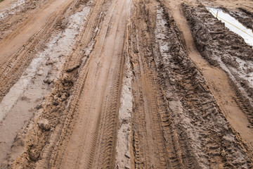 Texture of the road after rain which traces its wheels of truck and motorcycle