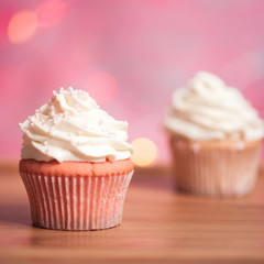Homemade cupcakes with cream cheese on top closeup. Selective focus.