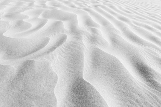 Sand  ripples texture shadows desert dune black and white.