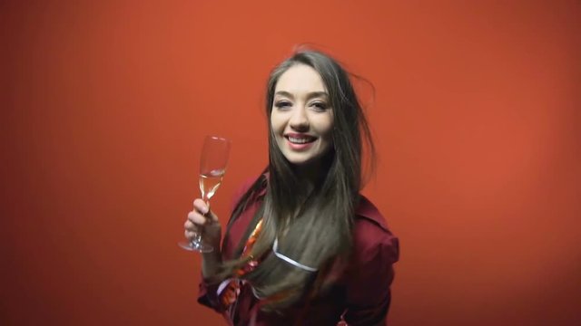a new year party brunette girl having fun with bocal of champaign