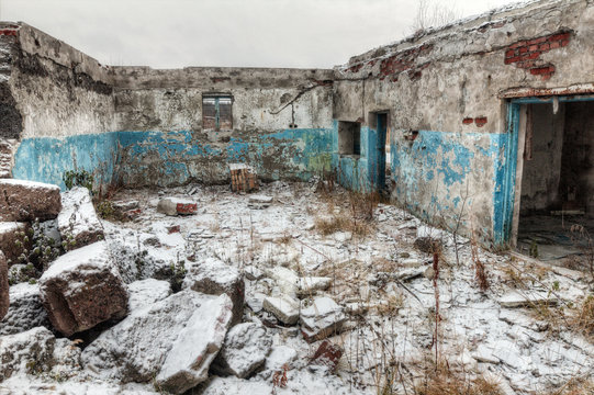 Apocalyptic landscape.The remains of destroyed houses covered with snow
