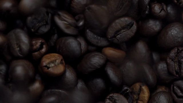 Rotating and falling Coffee beans. Slow Motion
