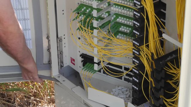 Technician working in the telecommunications outdoor box