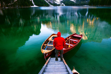 Man alone at the Braies Lake ( Pragser Wildsee ) in Dolomites mo