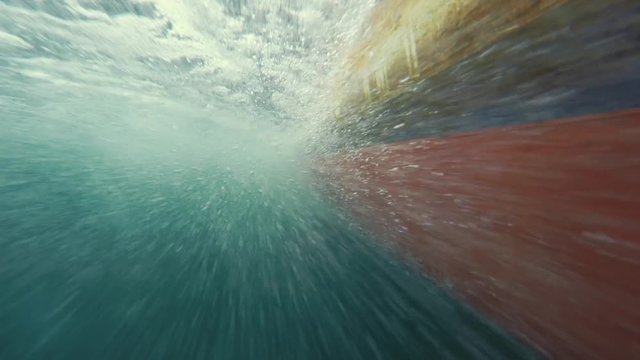 Underwater shot of bubbles passing by a fishing boat hull