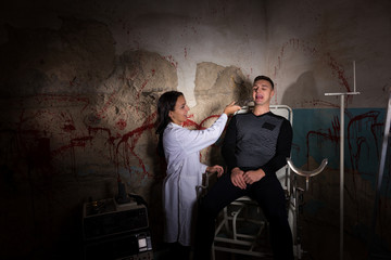 Crazy scientist holding medical forceps in front of patient in d