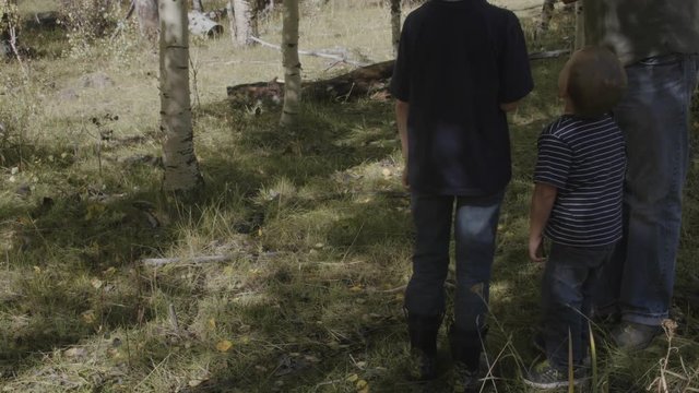 A father teaching his boys to shoot a bb gun