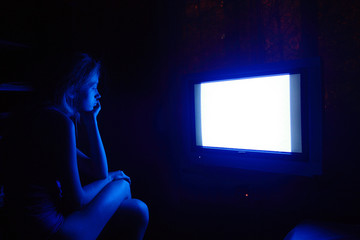 Fototapeta na wymiar sad caucasian woman watching tv at night