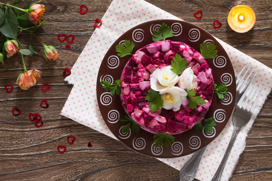 Holiday beet salad, decorated with flowers from the egg and pars