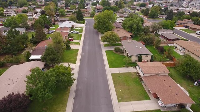 Aerial shot of cars on road in city suburbs