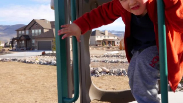 Boys playing outside on playset