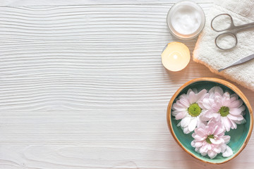 spa nail care with tea candle wooden background top view