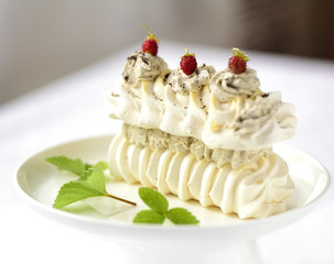 meringue cake with fresh berries on white background