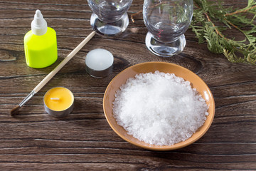 Sea salt, glue, glass on the wooden table. Children's Art Projec