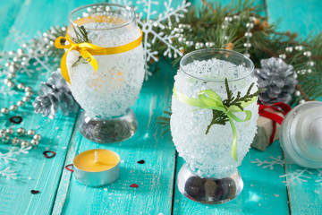 Children create a candlestick Christmas gift, candle in a glass