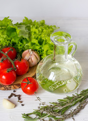 tomato with olive oil on wooden background close up